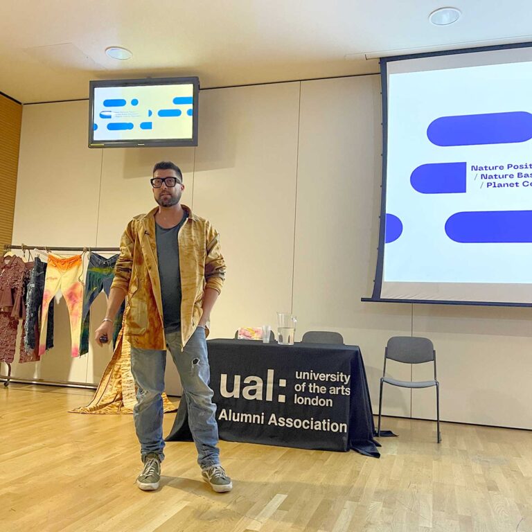 Jani in Luna's rust jacket delivering presentation at UaL